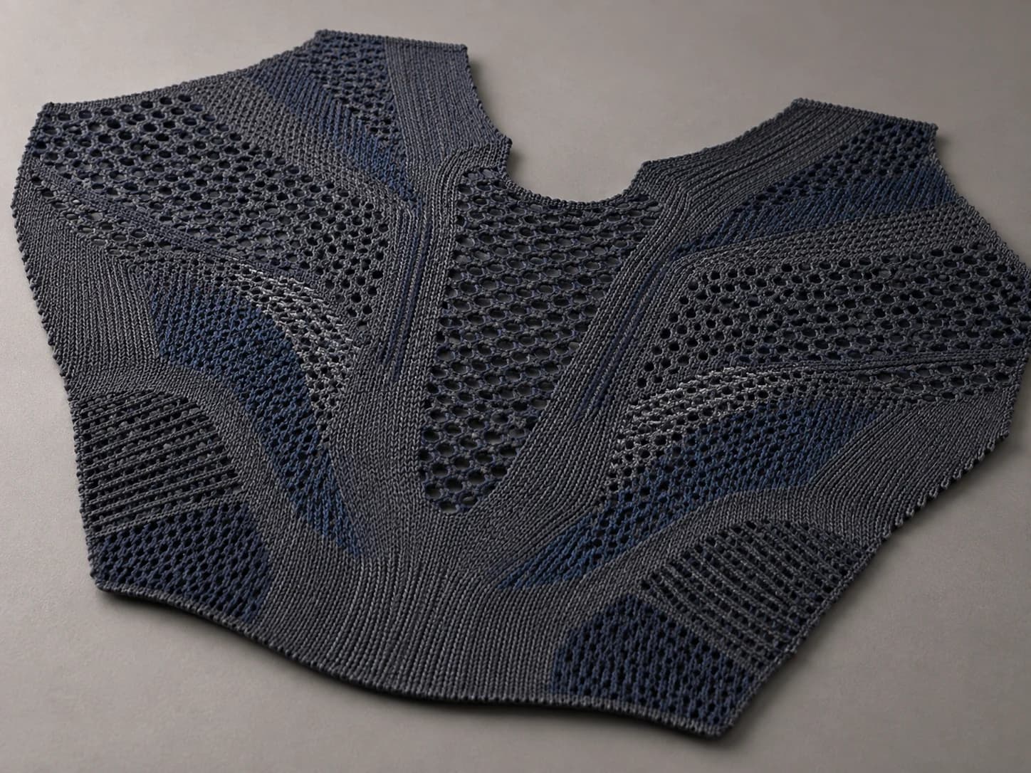 Concept view of an unbranded engineered knit mesh panel with localized reinforcement